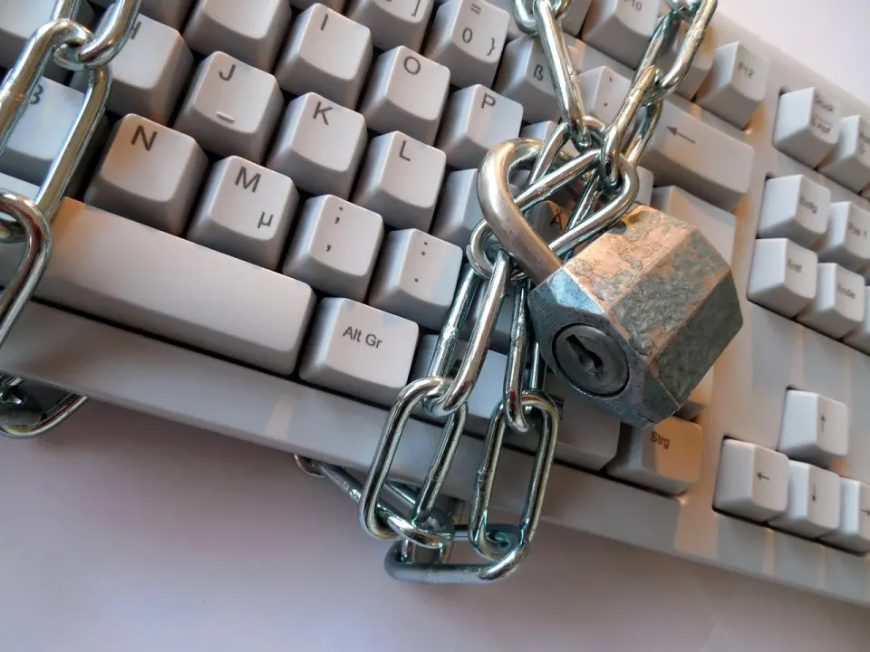 A padlock resting on a keyboard, a picture of locking down business accounts