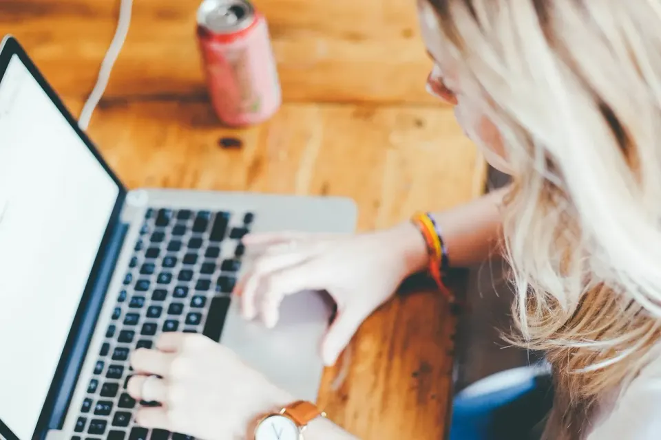 A laptop with a spreadsheet open on a desk, the kind of work Copilot is meant to speed up